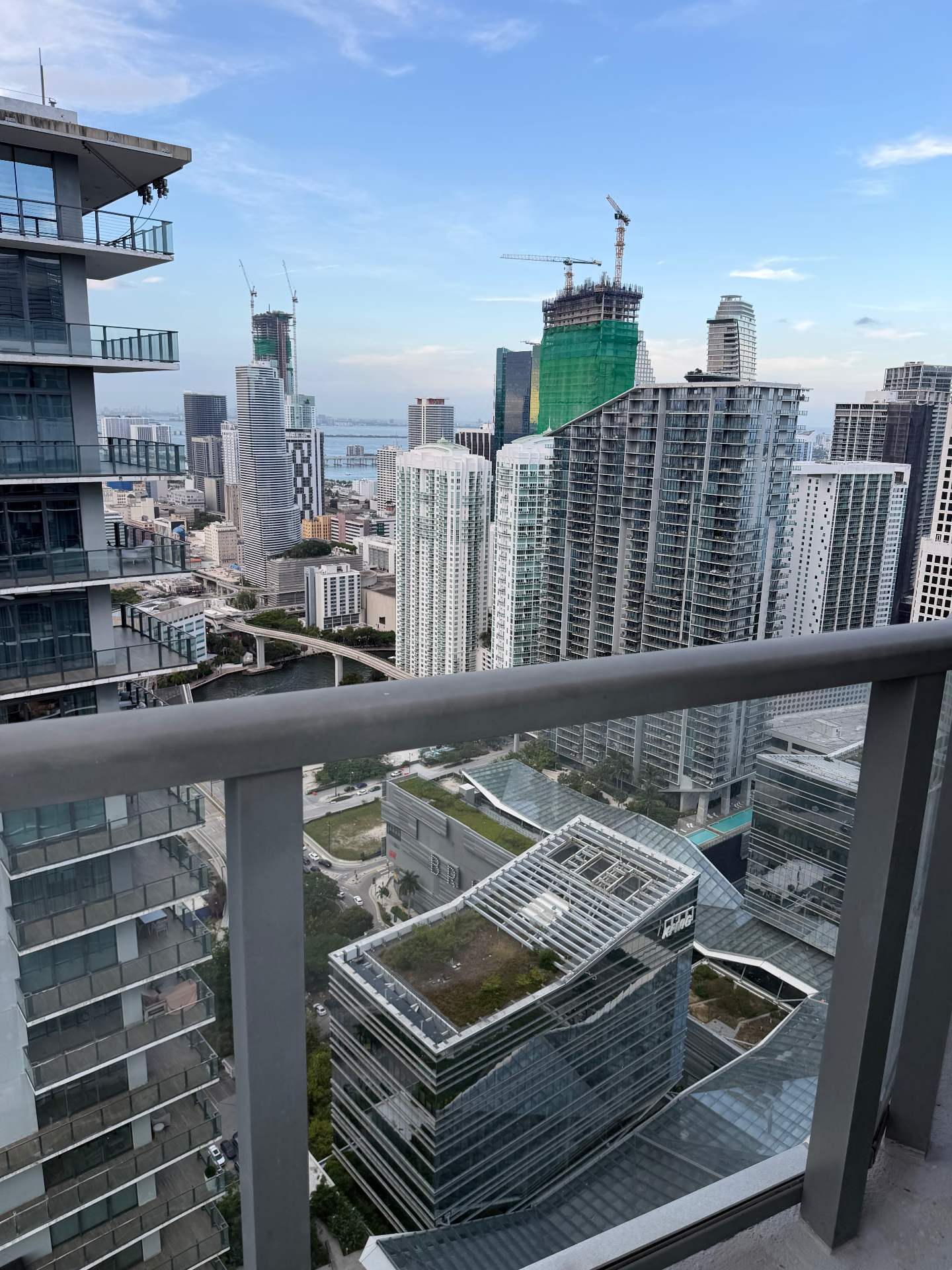 City skyline of glass towers seen from a high balcony at dusk